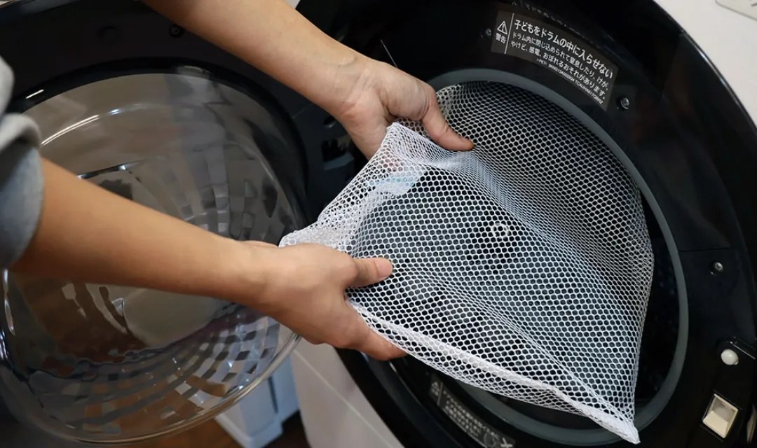 Guardner Belt going into a washing machine in a laundry bag